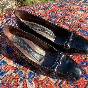 Patent leather Peter Kaiser pumps with horse bit decorative design. Leather sole